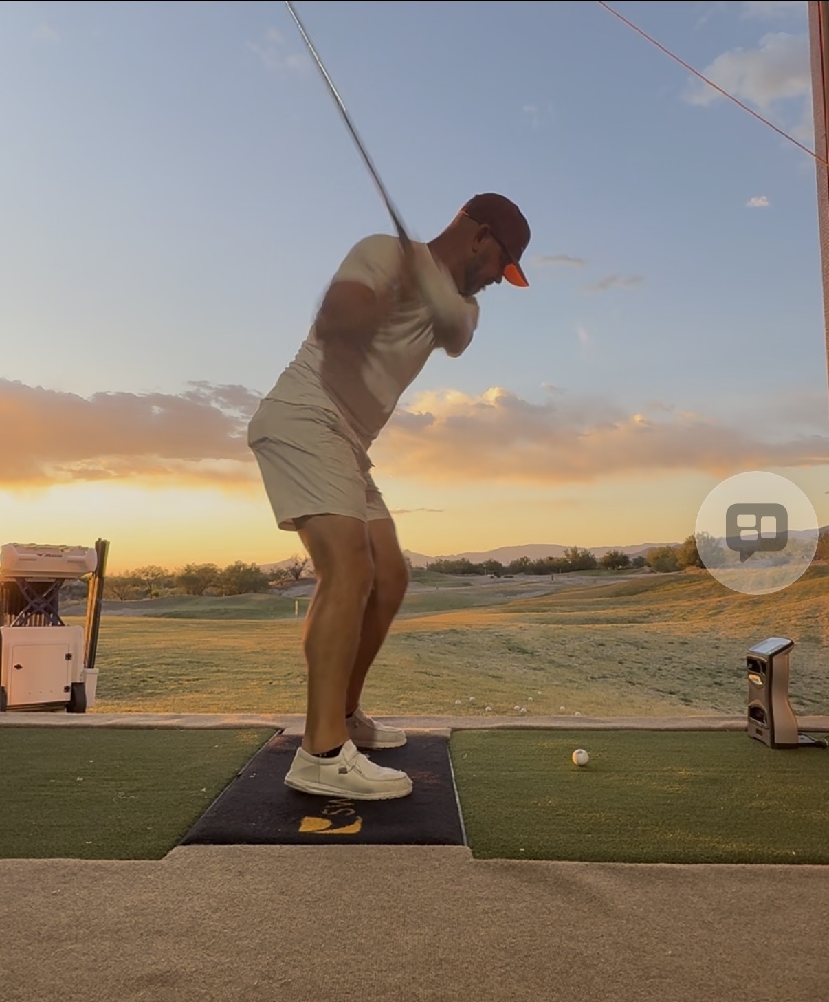 Coach Justin Kent at the top of his backswing at sunset